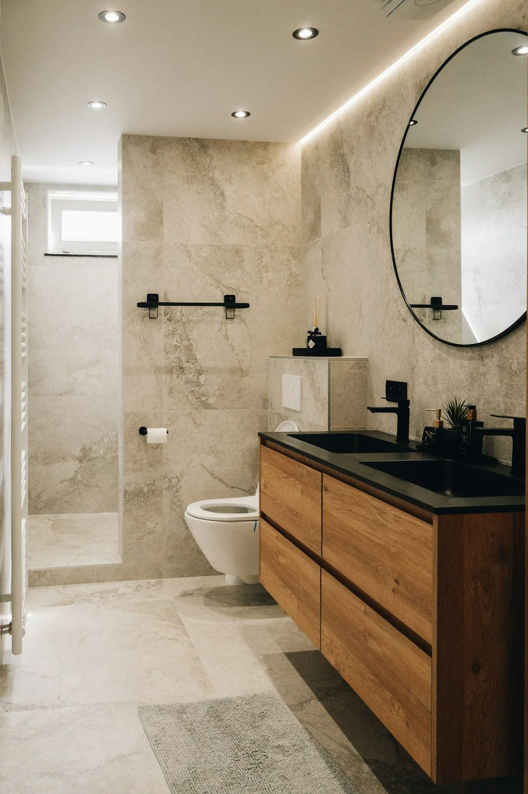 A cleaner operates a vacuum in a refined indoor space, highlighting cleaning tools and methods.